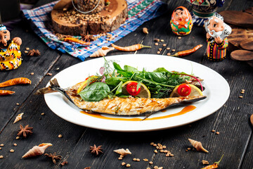 Fried fish stuffed with fresh greens and lemons