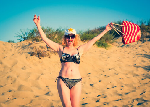 Pretty Middle Aged Woman In Black Shiny Swimsuit Enjoying Sand Tropical Beach. Travel And Beach Vacation Concept