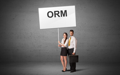 business person holding a traffic sign with ORM inscription, new idea concept