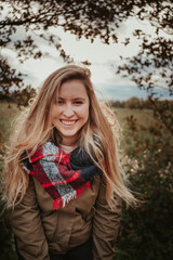 Girl in autumn forest nature with brown colors