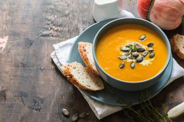 pumpkin and carrot cream soup with pumpkin seeds and toasted bread