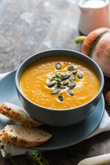 pumpkin and carrot cream soup with pumpkin seeds and toasted bread