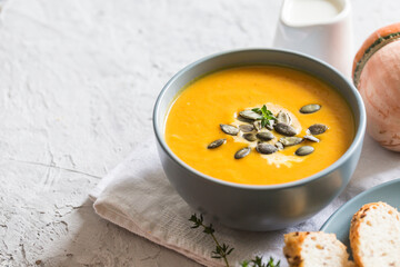 pumpkin and carrot cream soup with pumpkin seeds and toasted bread