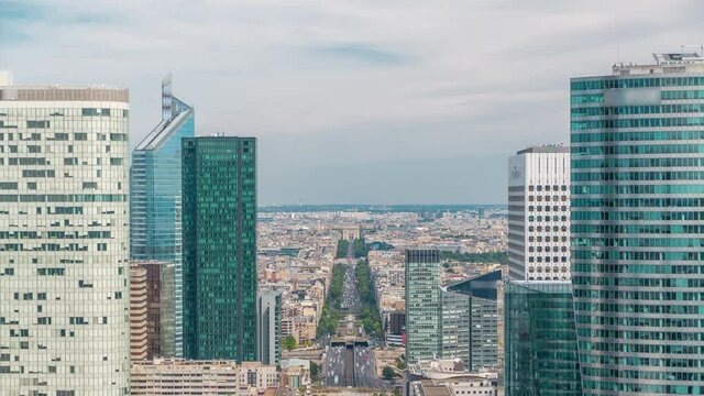 Aerial view of Paris and modern towers timelapse from the top of the skyscrapers in Paris business district La Defense. Sunny summer day with blue cloudy sky. Paris, France