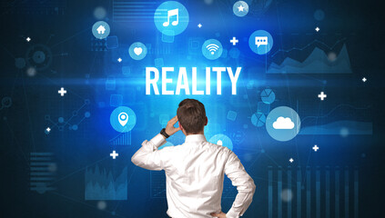 Rear view of a businessman with REALITY inscription, modern technology concept