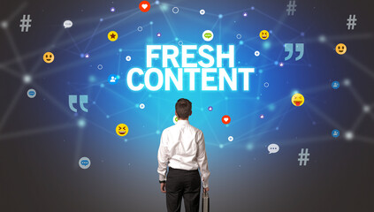 Rear view of a businessman with FRESH CONTENT inscription, social networking concept