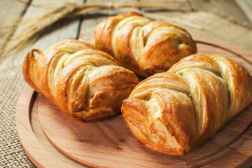 Puff pastry with apple - turnovers for dessert on a wooden table