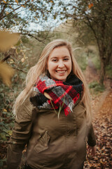 Girl in autumn forest nature with brown colors