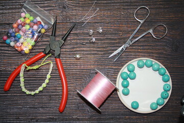 Fototapeta na wymiar Making jewelry, home workshop background.