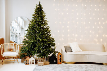 Beautiful festively decorated room with a Christmas tree. Cozy bright living room with stylish...
