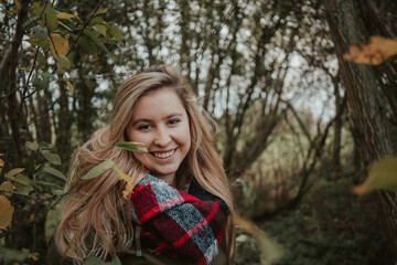 Girl in autumn forest nature with brown colors