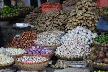 Baskets wit onions, garlic and ginger on a market in Vietnam