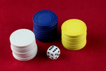 Gambling Chips and Die on a Red Background