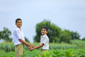 Cute indian child playing at green field