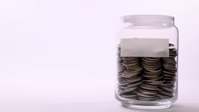 Coin in saving jar with empty label - Stop motion