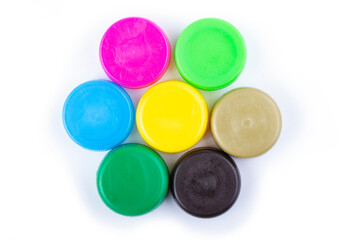 Group of multi colored bottle caps on a white background. Recycling and reuse concept. Space for text.