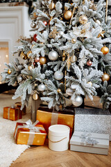 Close-up of Christmas presents in wrapping paper are on the floor under the Christmas tree