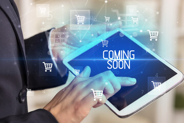 Young person makes a purchase through online shopping application with COMING SOON inscription