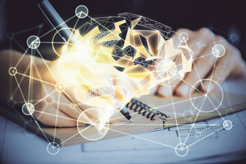 Multi exposure of writing hand on background with brain hologram. Concept of learning.
