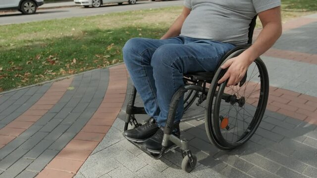 Handicapped man in wheelchair walk at the park alley