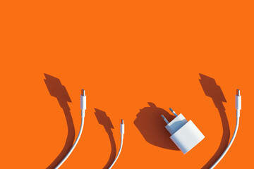 wires and charger for the phone on a bright orange background.