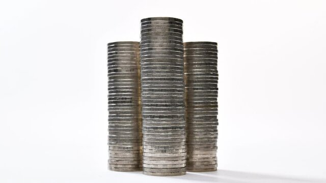Coins on stack increasing on white background - stop motion