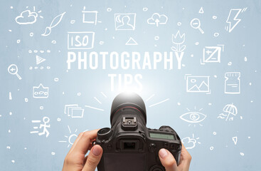 Hand taking picture with digital camera and PHOTOGRAPHY TIPS inscription, camera settings concept