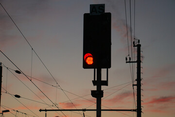 A traffic light in the foreground - a sunset in the background