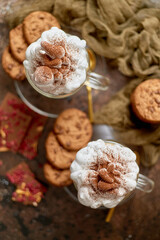 Sweet dessert served. Hot chocolate with whipped cream on top and cookies