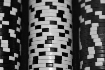 Black and white abstract of poker chips in a rack