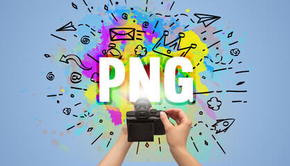 Close-up of a hand holding digital camera with abstract drawing and PNG inscription