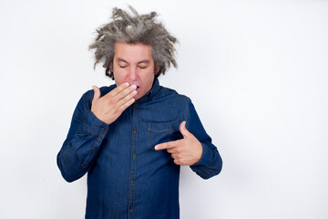 Shocked Handsome mature caucasian man with afro grey hair standing over isolated white background...