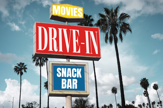 aged and worn drive-in movies sign