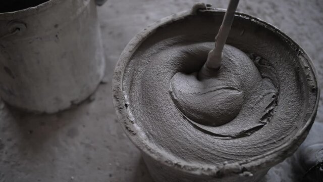 footage of mixing concrete mortar