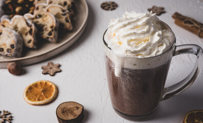 Winter hot drink, cacao with Christmas stollen on wooden board with dried fruits and nuts....
