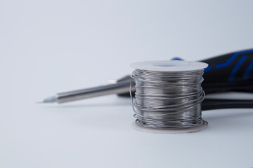 Solder for soldering with a soldering iron in a Bay on a white background.