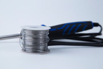 Solder for soldering with a soldering iron in a Bay on a white background.