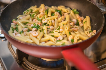 Penne with fresh shrimps in the frying pan