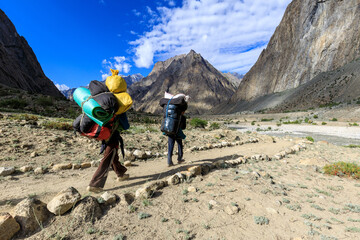 Porter between Camp Saitcho and Hushe, coming down from Concordia via Gondogoro La, Karakoram,...