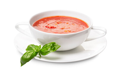Gazpacho in a white plate and basil