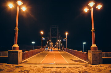 Pedestrian bridge entrance at night with LED lights and lanterns. Kyiv