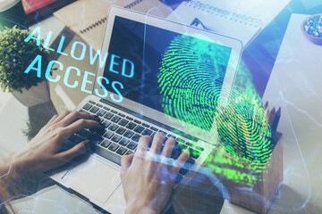 Fingerprint hologram with businessman working on computer on background. Security concept. Double exposure.