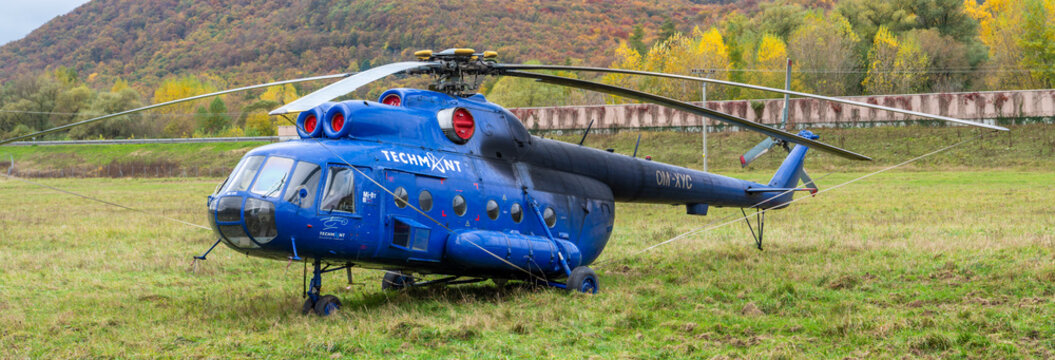 Tekovska Breznica, Slovakia - October, 31, 2020 : Blue helicopter Mil Mi 8T parking on the meadow.