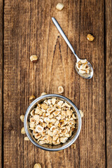 Portion of freshly chopped Hazelnuts (close up; selective focus)