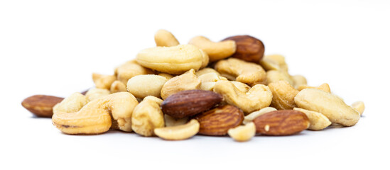 Roasted nuts isolated on white (close up; selective focus)