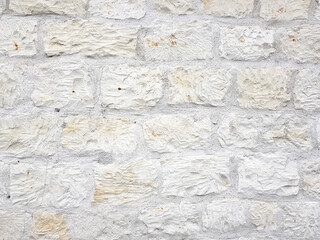 Bright natural limestone rough structure white wall texture background.