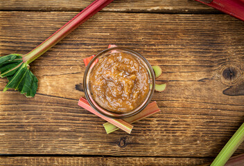 Rhubarb Jam on an old wooden table (close up shot; selective focus)