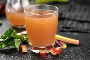 Rhubarb Juice on rustic background (close up; selective focus)