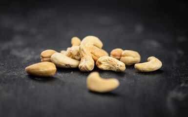 Some roasted Cashew Nuts (close up; selective focus)