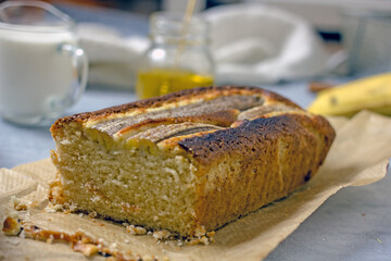 Homemade Vegan Gluten Free Banana Bread Sugar Free. Oatmeal bread with banana, honey and nuts in a baking dish on a gray table surrounded by ingredients. Top view, flat lay. Healthy sweets concept